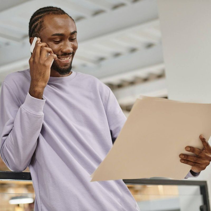 happy-african-american-man-looking-at-project-on-paper-talking-on-smartphone-planning-startup-r0zqwhf5frx45od5pju9nj75tegg2ng5p99rxgpav4 -- 1