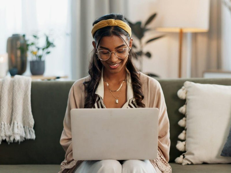 laptop-remote-work-and-happy-woman-on-a-sofa-for-social-media-research-or-reading-a-home-tech-f-r0zqwhf5frvz8hol1ehclbj51pk1ivhsiaa3vjncs0